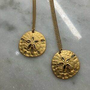 2 SAND DOLLAR SHELL NECKLACES, gold tone, 12” drop, 1 3/4” across